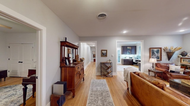 hallway with light hardwood / wood-style floors