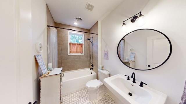 full bathroom featuring shower / tub combo with curtain, sink, toilet, and tile patterned flooring