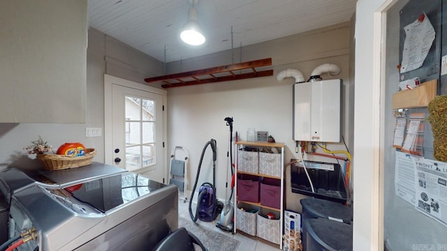 clothes washing area with independent washer and dryer, cabinets, and water heater