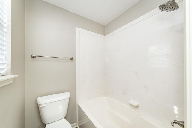 bathroom featuring shower / bathing tub combination and toilet