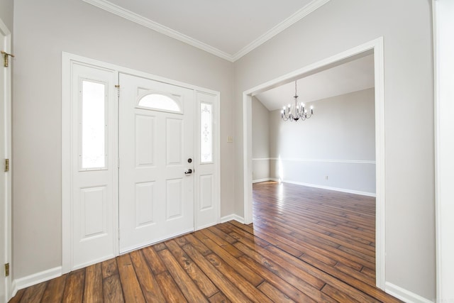 foyer featuring crown molding, dark hardwood / wood-style floors, and a notable chandelier