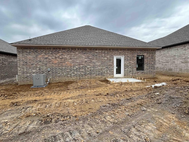 rear view of property with cooling unit