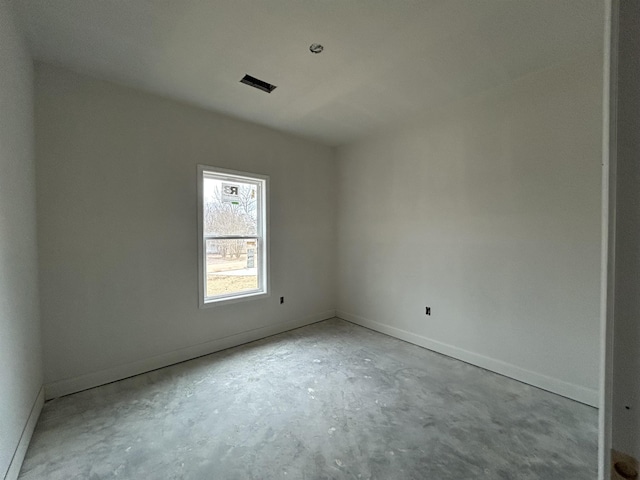 unfurnished room with concrete floors