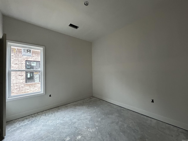 spare room with a healthy amount of sunlight and concrete flooring