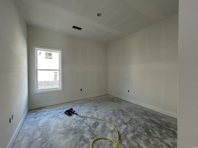 unfurnished room featuring concrete floors