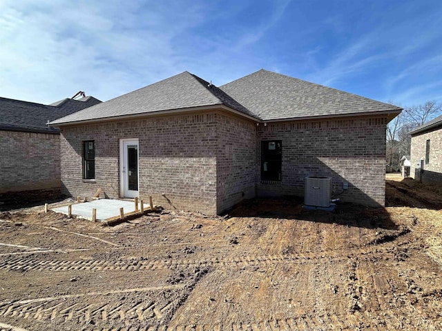 rear view of property with cooling unit and a patio area