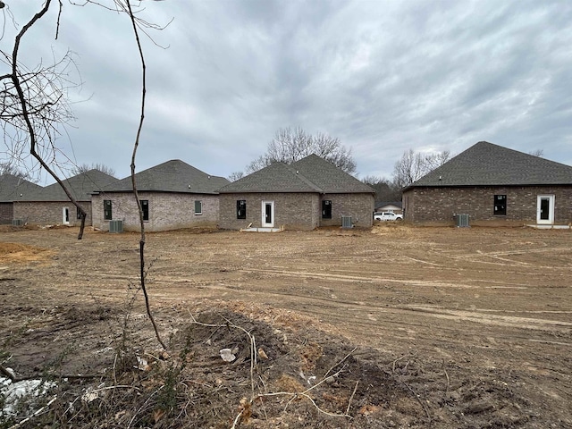 rear view of property featuring central AC