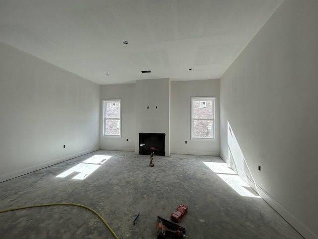 unfurnished living room featuring a wealth of natural light