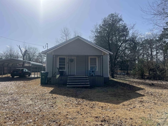 view of front of home with a carport and covered porch