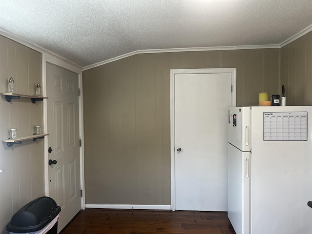 interior space with dark hardwood / wood-style flooring, crown molding, and a textured ceiling