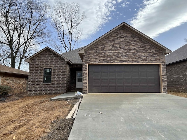 ranch-style home with stone siding, roof with shingles, concrete driveway, a garage, and brick siding