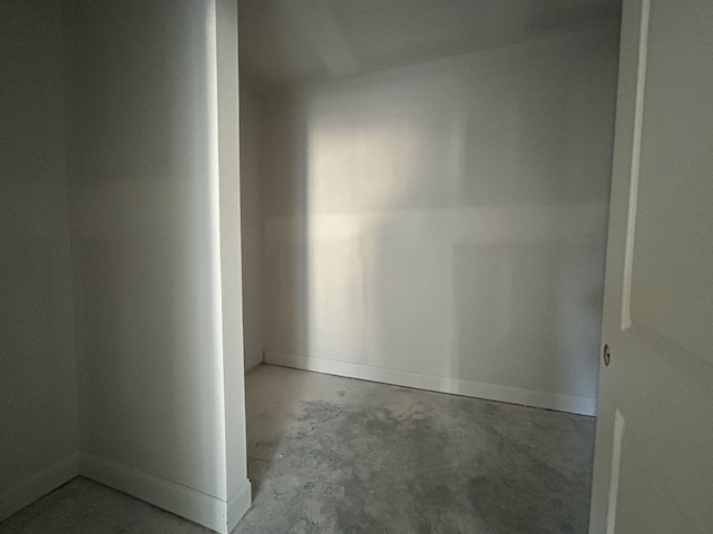 unfurnished room featuring concrete floors