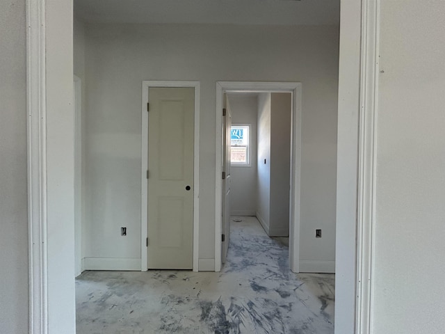 hallway featuring baseboards