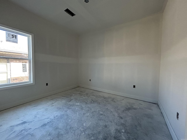 empty room with baseboards and concrete floors