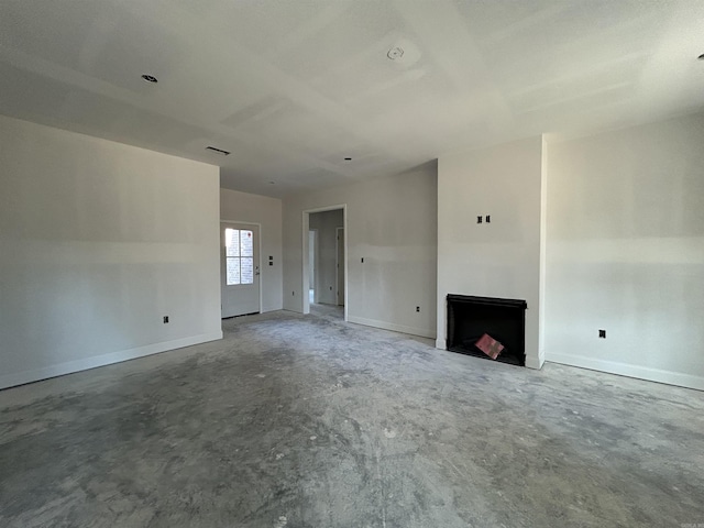 unfurnished living room featuring visible vents, a fireplace, and baseboards