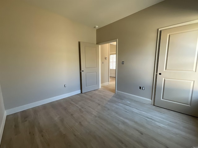 unfurnished bedroom featuring baseboards and wood finished floors