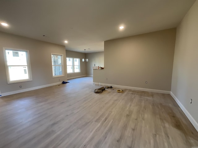 spare room featuring recessed lighting, wood finished floors, and baseboards