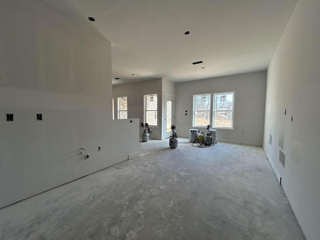 unfurnished living room featuring plenty of natural light