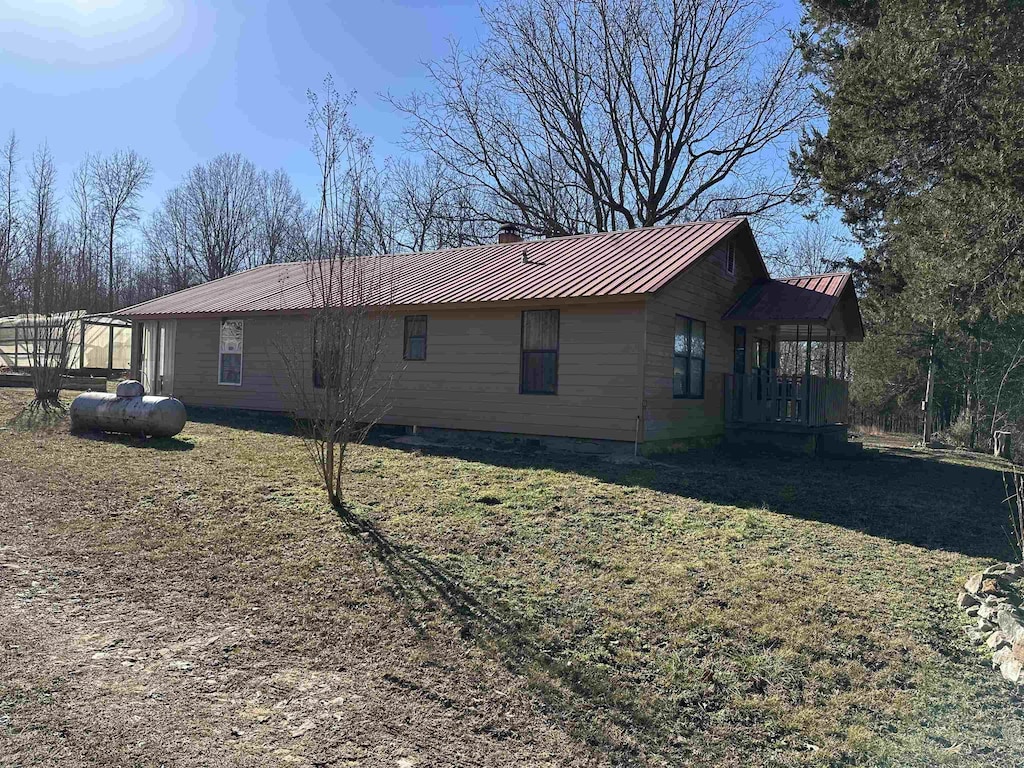 view of side of home featuring a lawn