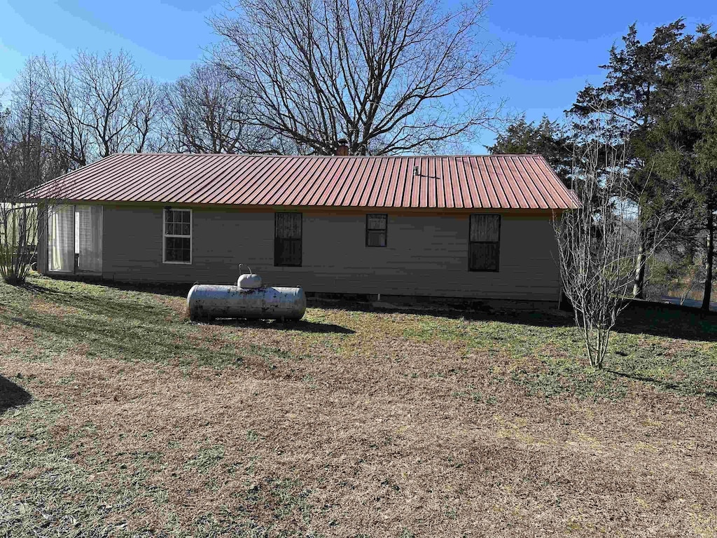 view of side of home with a lawn