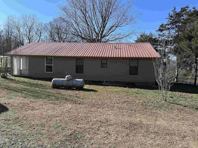 view of side of home with a lawn