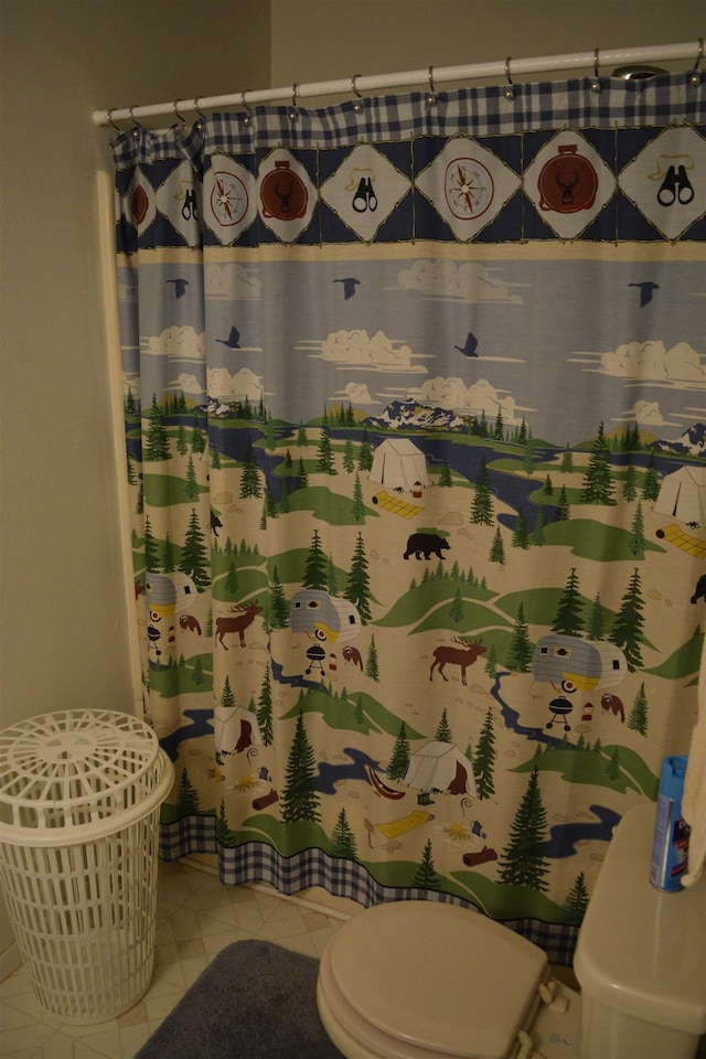 bathroom with tile patterned floors and toilet