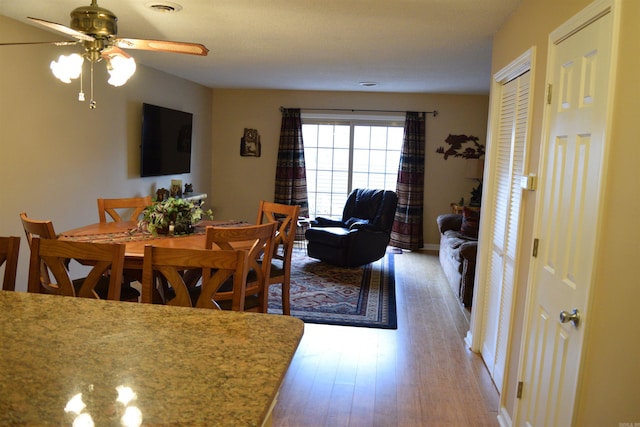 dining room featuring hardwood / wood-style floors and ceiling fan