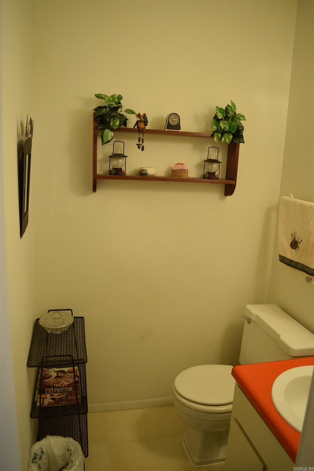 bathroom featuring vanity, tile patterned floors, and toilet