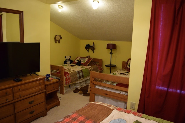 bedroom with lofted ceiling, light colored carpet, and a textured ceiling