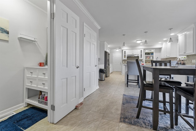 dining space featuring crown molding