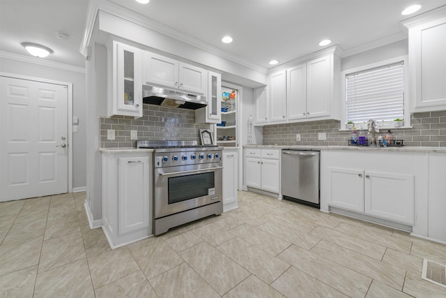 kitchen with appliances with stainless steel finishes, tasteful backsplash, sink, white cabinets, and crown molding