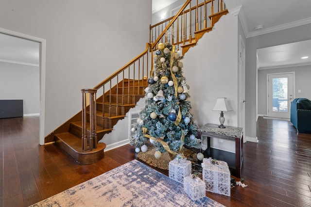 stairs featuring hardwood / wood-style flooring and ornamental molding