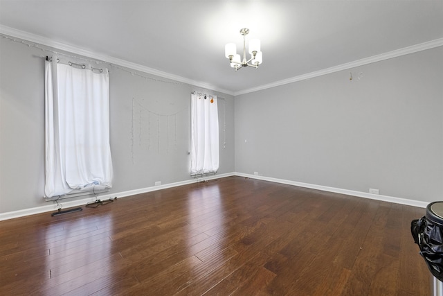 empty room with crown molding, a notable chandelier, and hardwood / wood-style flooring