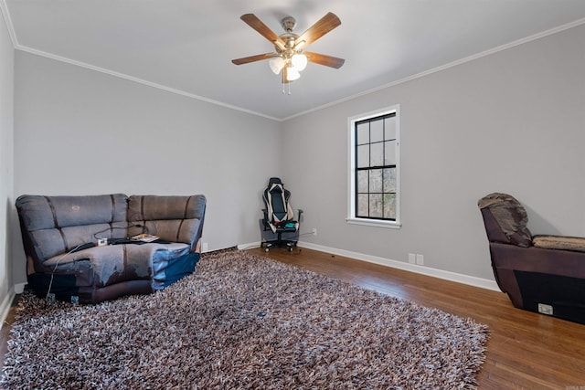 living area with crown molding, ceiling fan, and wood-type flooring