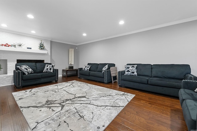 living room with ornamental molding, dark hardwood / wood-style floors, and a fireplace