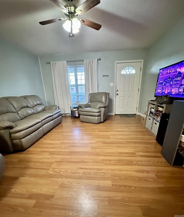 living room with light hardwood / wood-style flooring and ceiling fan