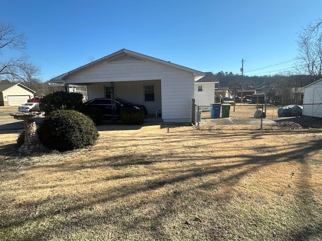 view of side of home featuring a carport and a lawn