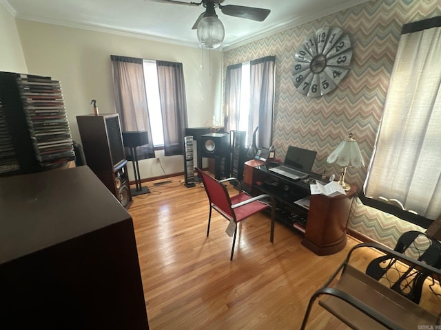 office area featuring ornamental molding, ceiling fan, and light wood-type flooring