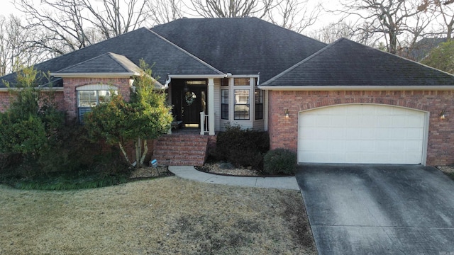 ranch-style home with a garage and a front yard