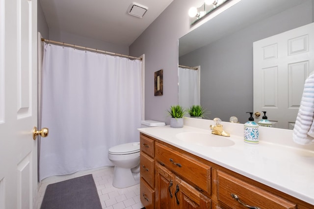 bathroom with vanity, tile patterned floors, and toilet