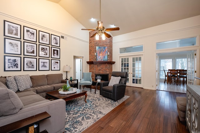 living room featuring ceiling fan, high vaulted ceiling, dark hardwood / wood-style floors, a fireplace, and french doors