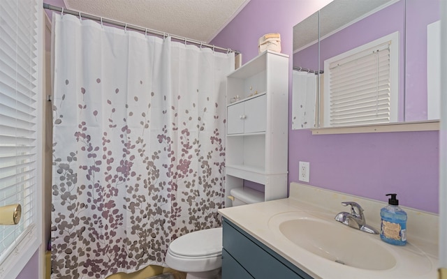 bathroom with vanity, curtained shower, toilet, and a textured ceiling