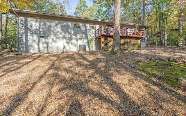 exterior space with a wooden deck and central AC unit