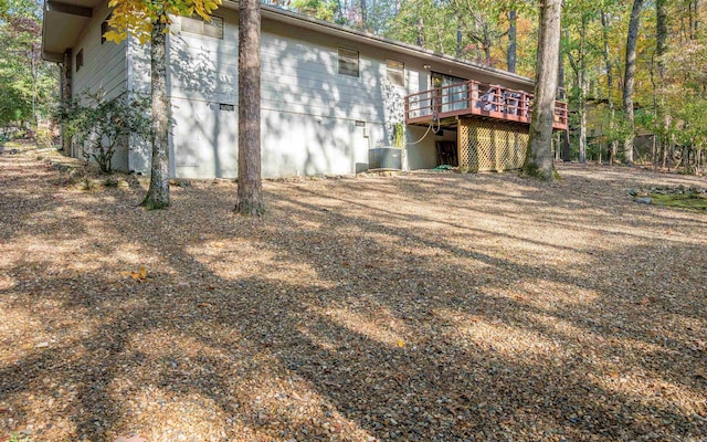 rear view of house with a wooden deck and central AC