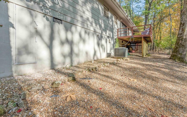 view of home's exterior featuring central AC unit and a deck