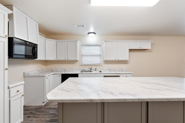 kitchen featuring white cabinetry, dark hardwood / wood-style floors, a center island, and sink