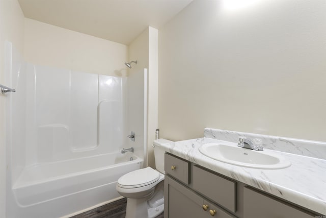 full bathroom with vanity, hardwood / wood-style flooring, shower / tub combination, and toilet