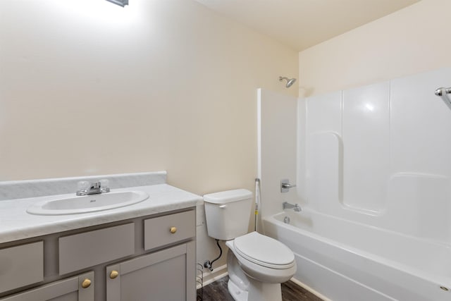 full bathroom with vanity, wood-type flooring, shower / bathtub combination, and toilet