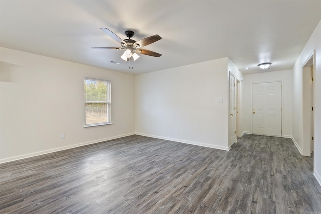 spare room featuring dark wood-type flooring and ceiling fan