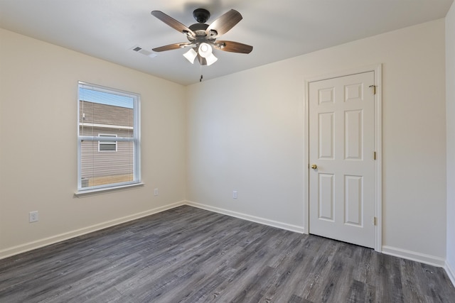 unfurnished room with ceiling fan and dark hardwood / wood-style floors